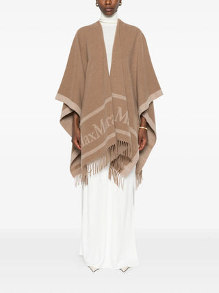Logo-print fringed poncho by MAX MARA. 100% wool with logo lettering and fringe detailing. A versatile layering piece for any occasion, available at our Lisbon store. 