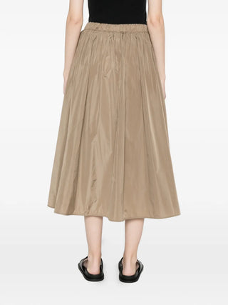 The Lonza midi skirt in silk-blend taffeta, elasticated waist for comfort and a flared A-line for movement. Available at our Lisbon store.