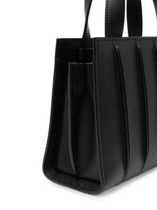 Paneled leather tote bag by Max Mara. Crafted from smooth calfskin. Features top handles, a detachable shoulder strap, and internal pockets. 
