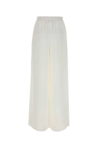Max Mara wide-leg trousers. Fluid palazzo silhouette, front pleats, and impeccable Italian craftsmanship. Timeless elegance, available at our Lisbon store. 