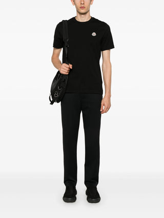 Moncler logo-patch trousers. Drawstring waist, signature patch, and premium materials. Effortless luxury, available at our Lisbon store.