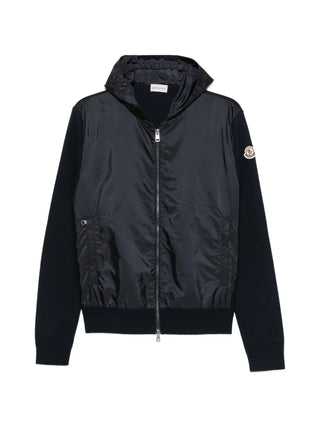 Moncler panelled hoodie with iconic logo patch. Cotton-jersey and quilted shell, zip fastening. Available at our Lisbon store.