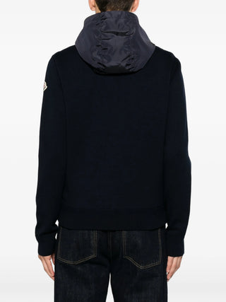 Moncler panelled hoodie with iconic logo patch. Cotton-jersey and quilted shell, zip fastening. Available at our Lisbon store.