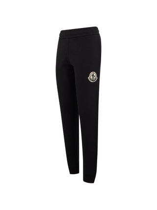 Moncler logo-patch track pants. Signature branding, premium fabric, and relaxed fit. Elevated athleisure. Available at our Lisbon store.