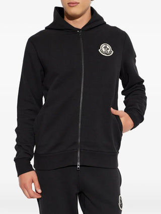 Moncler logo-patch zip-up hoodie. 100% cotton with signature logo patch at chest. A timeless essential,  available at our Lisbon store.
