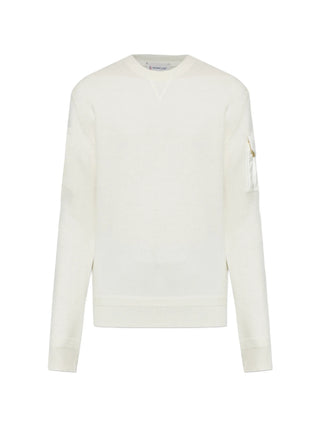 Moncler sweater with sleeve pocket and logo patch. Crewneck, soft wool, and refined utility. A modern essential. Available at our Lisbon store.