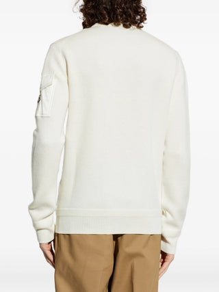 Moncler sweater with sleeve pocket and logo patch. Crewneck, soft wool, and refined utility. A modern essential. Available at our Lisbon store.