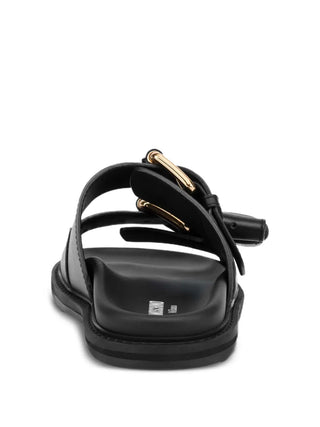 Moschino double-strap sandals crafted from 100% calf leather. Features a flatform silhouette, gold-tone buckles, and a chunky rubber sole. 