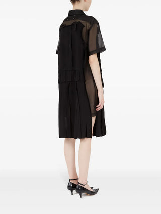 Maison Margiela black layered mesh midi dress with pleats and signature stitching. A refined sheer silhouette, available at our Lisbon store.