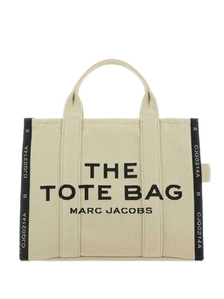Marc Jacobs The Jacquard Medium tote in sand beige with zip closure, dual handles, and adjustable strap. A structured everyday carry, available at our Lisbon store.