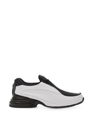 Nike Air Max Dolce. Moulded Phylon upper, webbed overlay cage, and visible Max Air cushioning in the heel. A laceless, dressy hybrid.