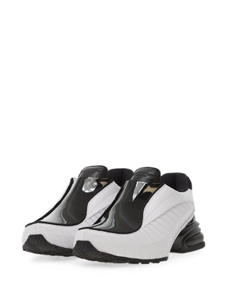 Nike Air Max Dolce. Moulded Phylon upper, webbed overlay cage, and visible Max Air cushioning in the heel. A laceless, dressy hybrid.