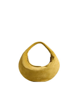 The Olivia Mini Hobo by KHAITE. Buttery leather, a compact curved silhouette, and a vivid yellow finish. This statement bag is available at our Lisbon store. 