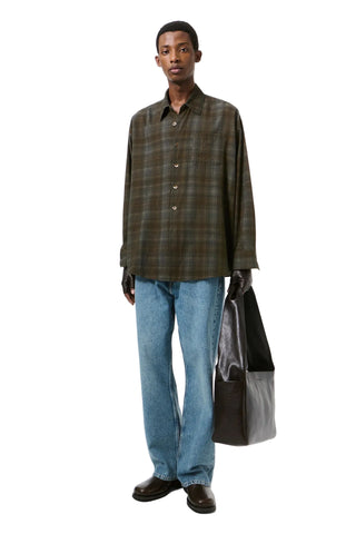 Our Legacy Borrowed Shirt. An oversized silhouette with mother of pearl buttons, mitered cuffs, and a curved hem. Available at our Lisbon store. 