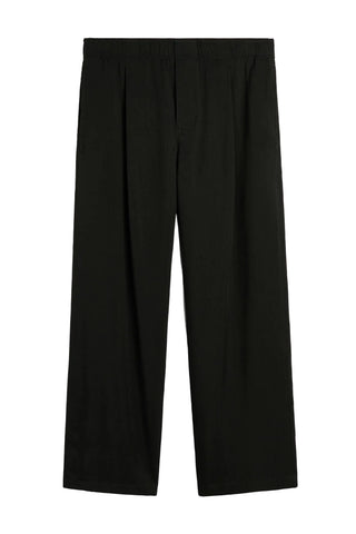 Our Legacy Leisure Trouser. Featuring an elasticated waistband, front pleats and wide-leg silhouette. Comfortable dress trousers, available at our Lisbon store.