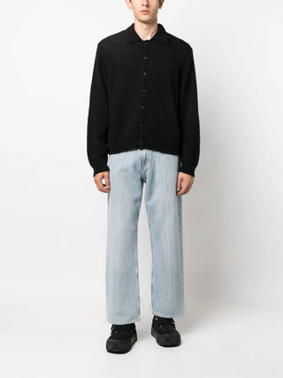 Our Legacy Evening Fuzzy Alpaca knit in black with polo collar and horn buttons. A refined layer, available at our Lisbon store.