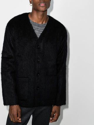 Our Legacy black hairy texture cardigan with relaxed fit and bone buttons. A refined layer, available at our Lisbon store.