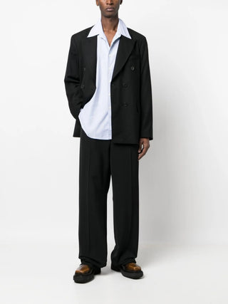Our Legacy black wool double-breasted blazer with peak lapels and tailored fit. A modern classic, available at our Lisbon store.