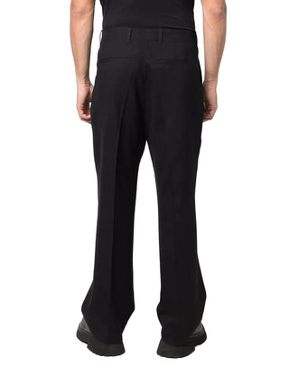 Crafted from virgin wool, these trousers feature a straight-leg with sharp pleats and finished with a zip fly, horn button detailing and side pockets.