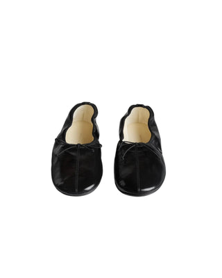 Gathered flat pump in black leather with a glossy sheen, rounded toe, rubber sole and in-built 10mm wedge for support and comfort. Grosgrain trim and tie.