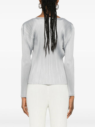 Person wearing the Pleats Please Issuey Miyake Monethly colours February top in Grey with white pants from the back. 
