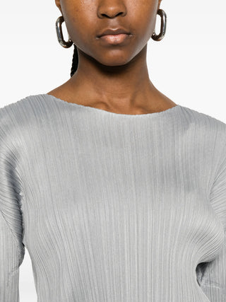 Close-up of person wearing the Pleats Please Issey Miyake Monthly colours top in Grey. 
