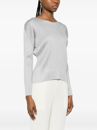 Person wearing Grey Pleats Please Issey Miyake Monthly colours: February with white pants. 