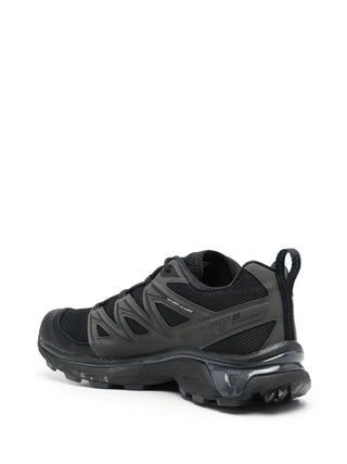 Salomon panelled mesh sneakers. Breathable 3D mesh upper with protective film. Quicklace™, EVA cushioning, and a chunky rubber lug sole for stability.