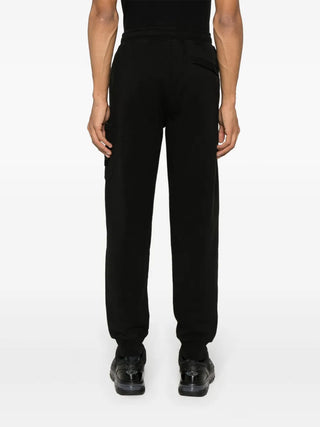 Track pants with the iconic detachable Compass badge. Cotton jersey, side pockets, and a modern tapered fit. Available at our Lisbon store. 