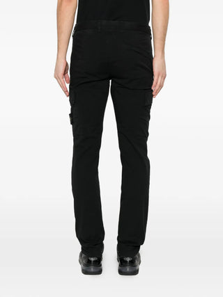 Stone Island logo-patch cargo pants in stretch cotton. A tapered fit with elasticated cuffs and  iconic removable compass badge. Available at our Lisbon store.