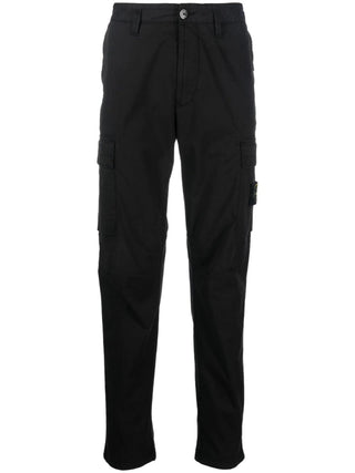 Logo-patch cargo pants from Stone Island. Crafted from stretch cotton with cargo pockets and an adjustable waist. Iconic badge, available at our Lisbon store. 