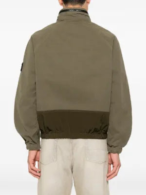 Logo-patch panelled jacket by Stone Island. Featuring a hood, multiple pockets, elasticated cuffs, and a garment-dyed finish. Available at our Lisbon store. 