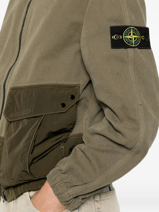 Logo-patch panelled jacket by Stone Island. Featuring a hood, multiple pockets, elasticated cuffs, and a garment-dyed finish. Available at our Lisbon store. 