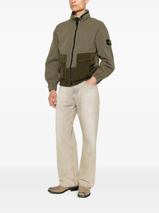 Logo-patch panelled jacket by Stone Island. Featuring a hood, multiple pockets, elasticated cuffs, and a garment-dyed finish. Available at our Lisbon store. 