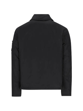Stone Island zip jacket with detachable Compass badge. Crafted from cotton, nylon, or stretch poplin. Available at our Lisbon store. 