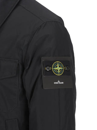 Stone Island zip jacket with detachable Compass badge. Crafted from cotton, nylon, or stretch poplin. Available at our Lisbon store. 