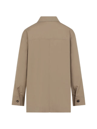 'S Max Mara Marianne cotton shirt. Pointed collar, chest pocket, horn buttons, and a modern asymmetrical hem with side slits. Available at our Lisbon store.