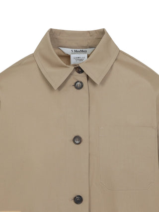 'S Max Mara Marianne cotton shirt. Pointed collar, chest pocket, horn buttons, and a modern asymmetrical hem with side slits. Available at our Lisbon store.