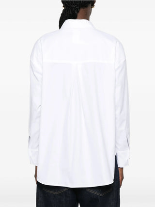 'S Max Mara Volonta shirt. Asymmetric hem, jewel buttons, and pure cotton. A modern classic with deep side slits. Available at our Lisbon store.