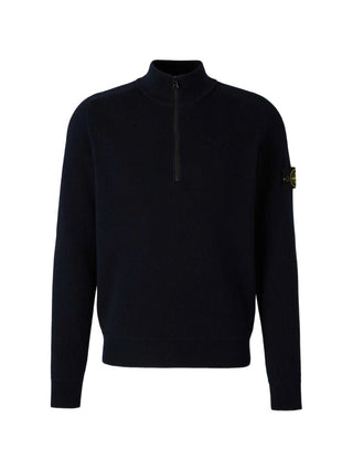 High-neck sweater from Stone Island. Ribbed mock neck, long sleeves, and iconic logo badge. Classic utilitarian warmth. Available at our LIsbon store. 