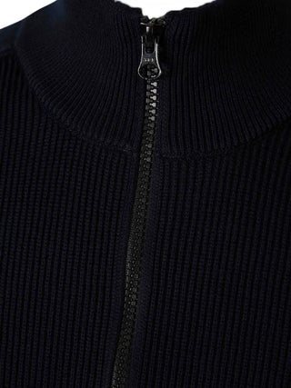 High-neck sweater from Stone Island. Ribbed mock neck, long sleeves, and iconic logo badge. Classic utilitarian warmth. Available at our LIsbon store. 