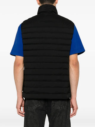 Stone Island quilted gilet with signature Compass logo-patch. Water-resistant shell and down fill for warmth. An utilitarian icon found at our Lisbon store. 