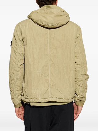 Stone Island hooded jacket with signature Compass patch. Functional hood, zip fastening, and technical fabric. Available at our Lisbon store. 