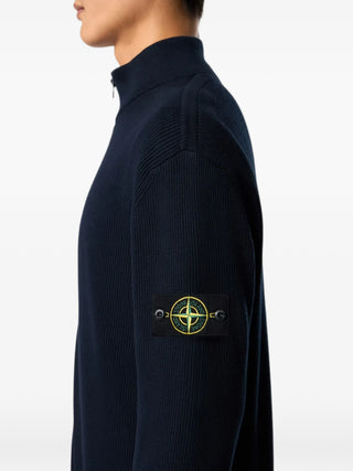 Ribbed cardigan with a high stand collar and zip fastening. Crafted from wool or cotton with the signature Stone Island badge on the sleeve. 