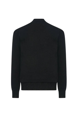 The Row V-neck cardigan in cashmere. Relaxed fit with black front buttons and long sleeves. Made in Italy. A quiet-luxury staple, available at our Lisbon store.
