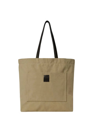 Tori canvas tote bag by THE ROW. Minimal silhouette, leather trim, front slot pocket, and button closure.  Available at our Lisbon store.