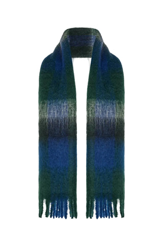 The Row Uma scarf in Blue. Crafted from 70% mohair and 30% virgin wool. A fringed, oversized accessory made in Italy. Available at our Lisbon store.