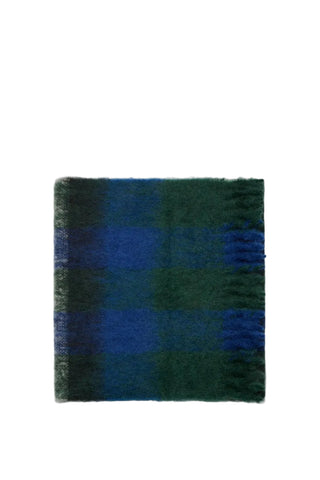 The Row Uma scarf in Blue. Crafted from 70% mohair and 30% virgin wool. A fringed, oversized accessory made in Italy. Available at our Lisbon store.
