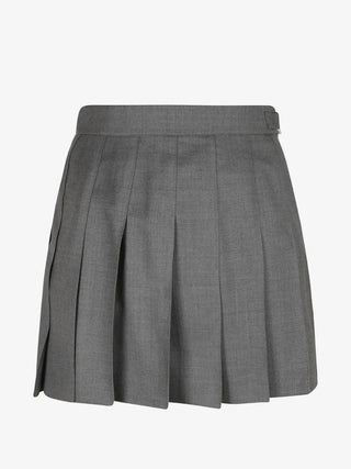 Thom Browne thigh-length skirt. Engineered 4-Bar stripe, knife pleats, and a stepped dropped-back hem. Tailored in 100% wool with a grosgrain loop tab.