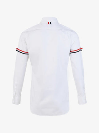 Thom Browne classic button-down shirt. Oxford cotton, 4-Bar detailing, and impeccable Italian craftsmanship. Available at our Lisbon store. 